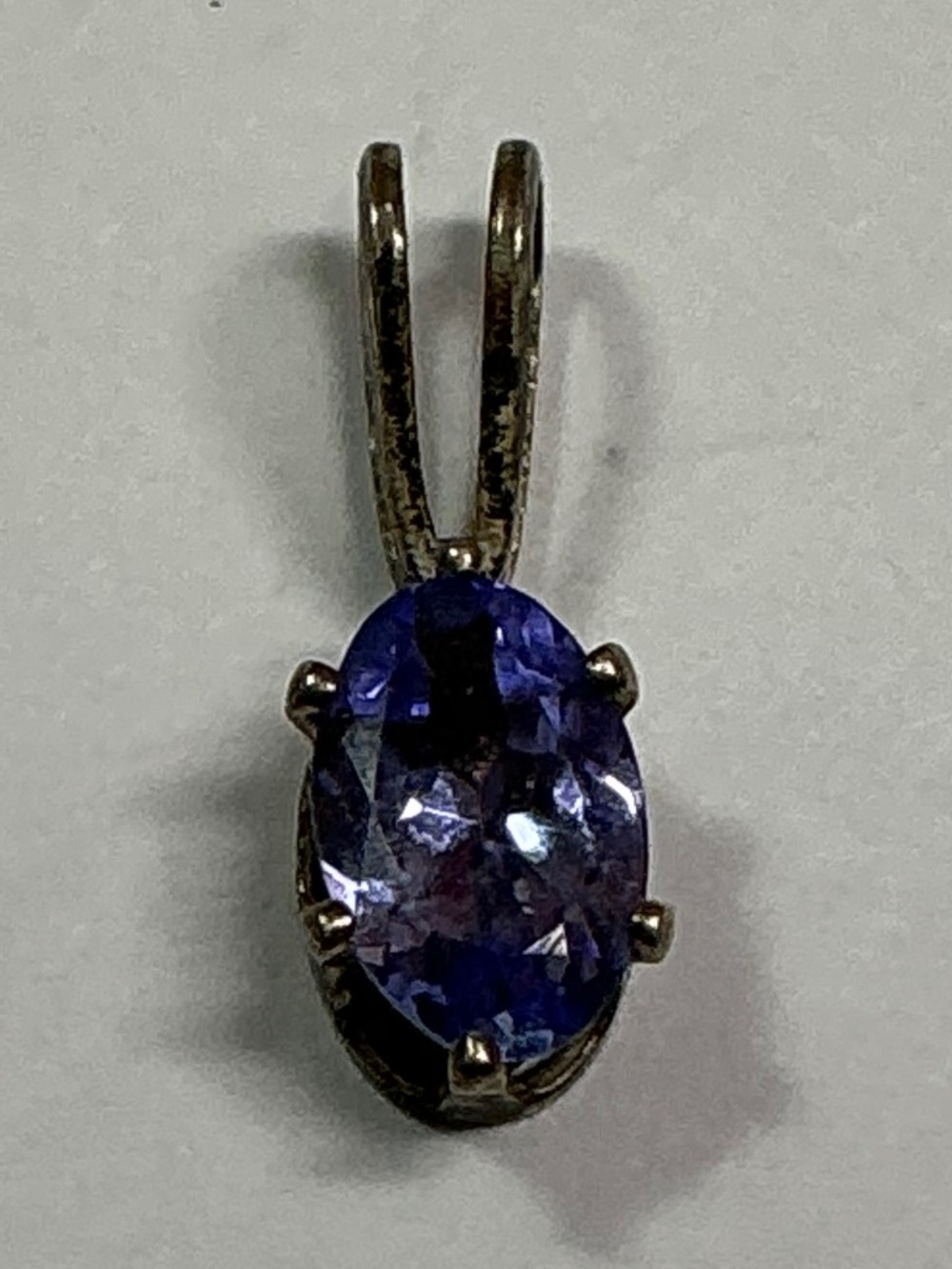 Sterling Silver Petite Blue Oval Shape Pendant. 1/2 inches long